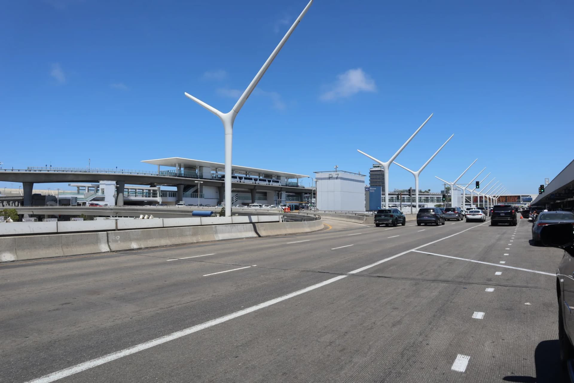 The LAX departures roadway with the airport gateway pylons and terminal walkways