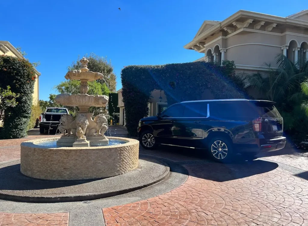 Luxury black SUV parked in Los Angeles skyline