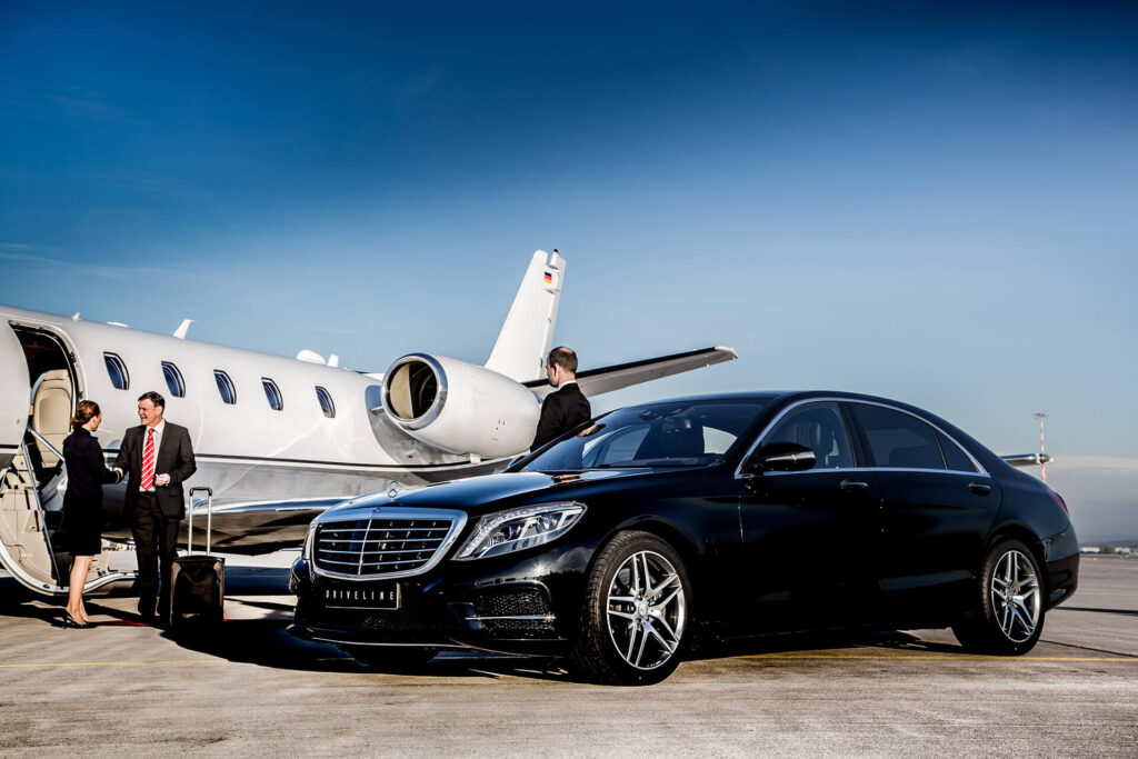 VIP CITY RIDES INC classic black luxury car parked beside a private jet on the tarmac, symbolizing premium chauffeur service.