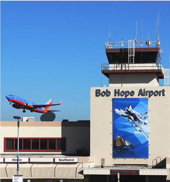 Bob Hope Airport Burbank terminal and control tower with luxury black SUV airport transportation service